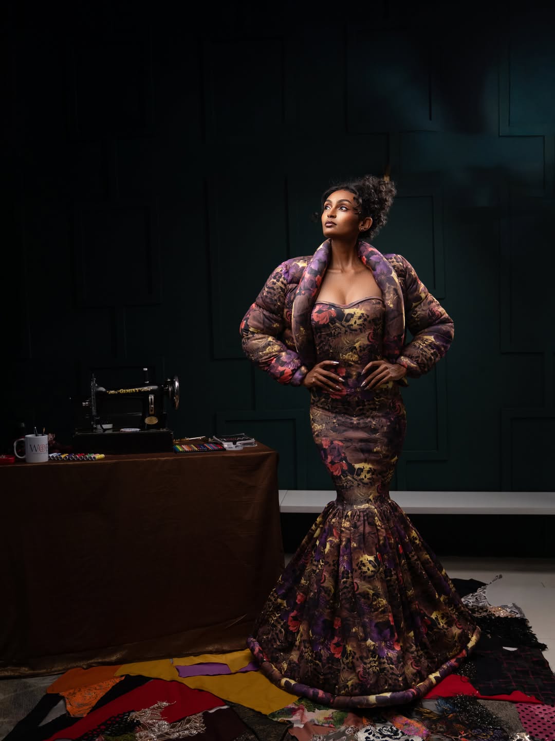 Model in the Sculptural gown with hands on hips in a confident pose